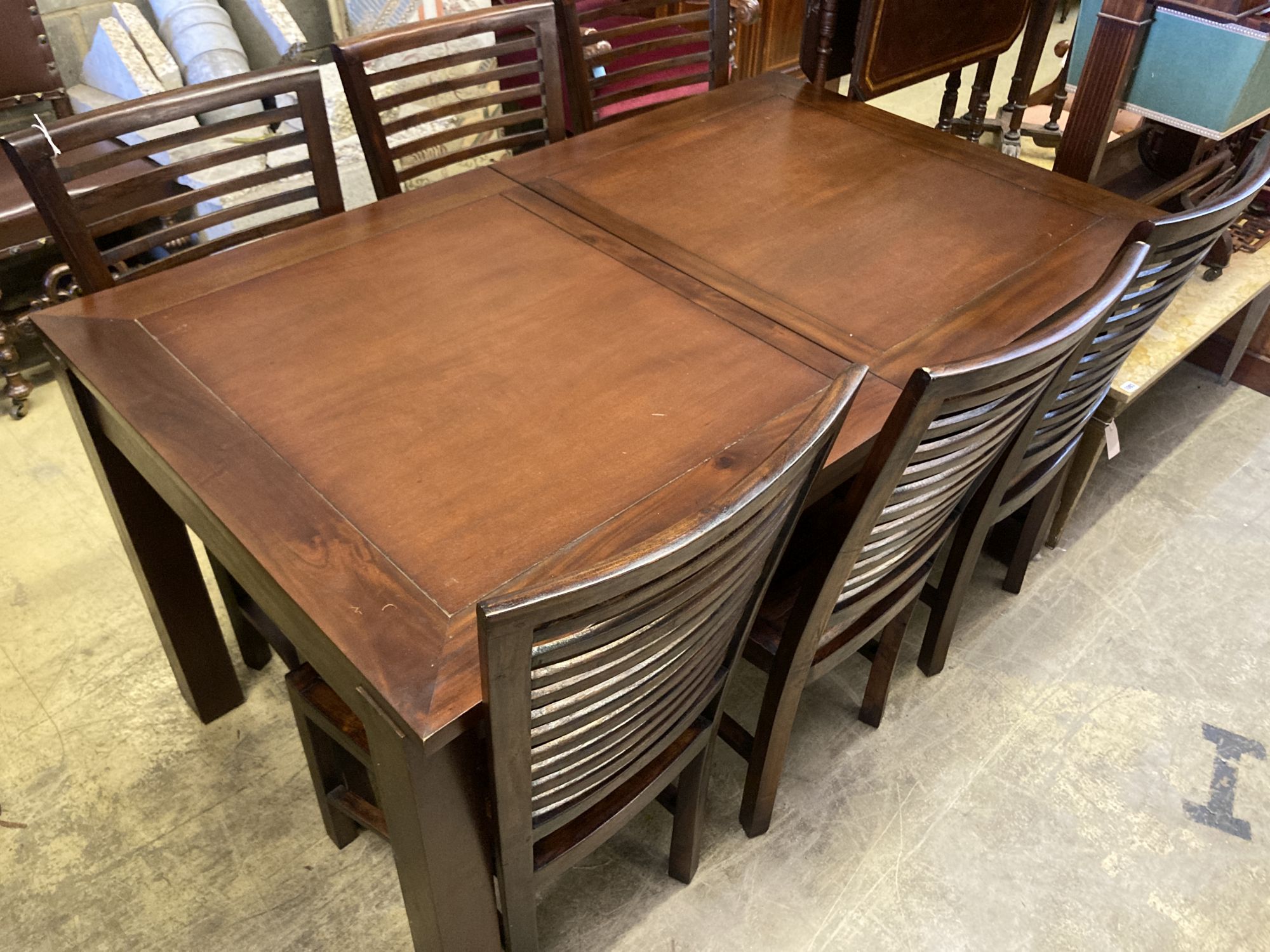 A contemporary rectangular hardwood extending dining table and six chairs, table length 150cm, depth 90cm, height 79cm